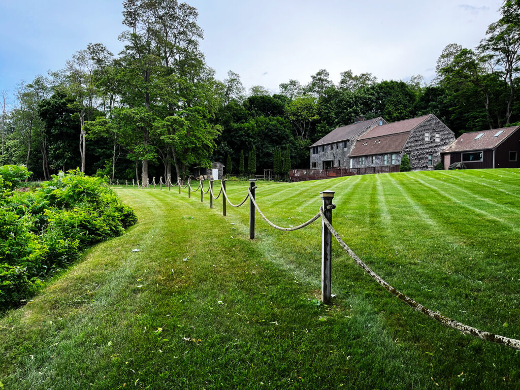 A picture looking from the other side of the rope fence on the edge of the cliff, looking towards the Bed and Breakfast main house.